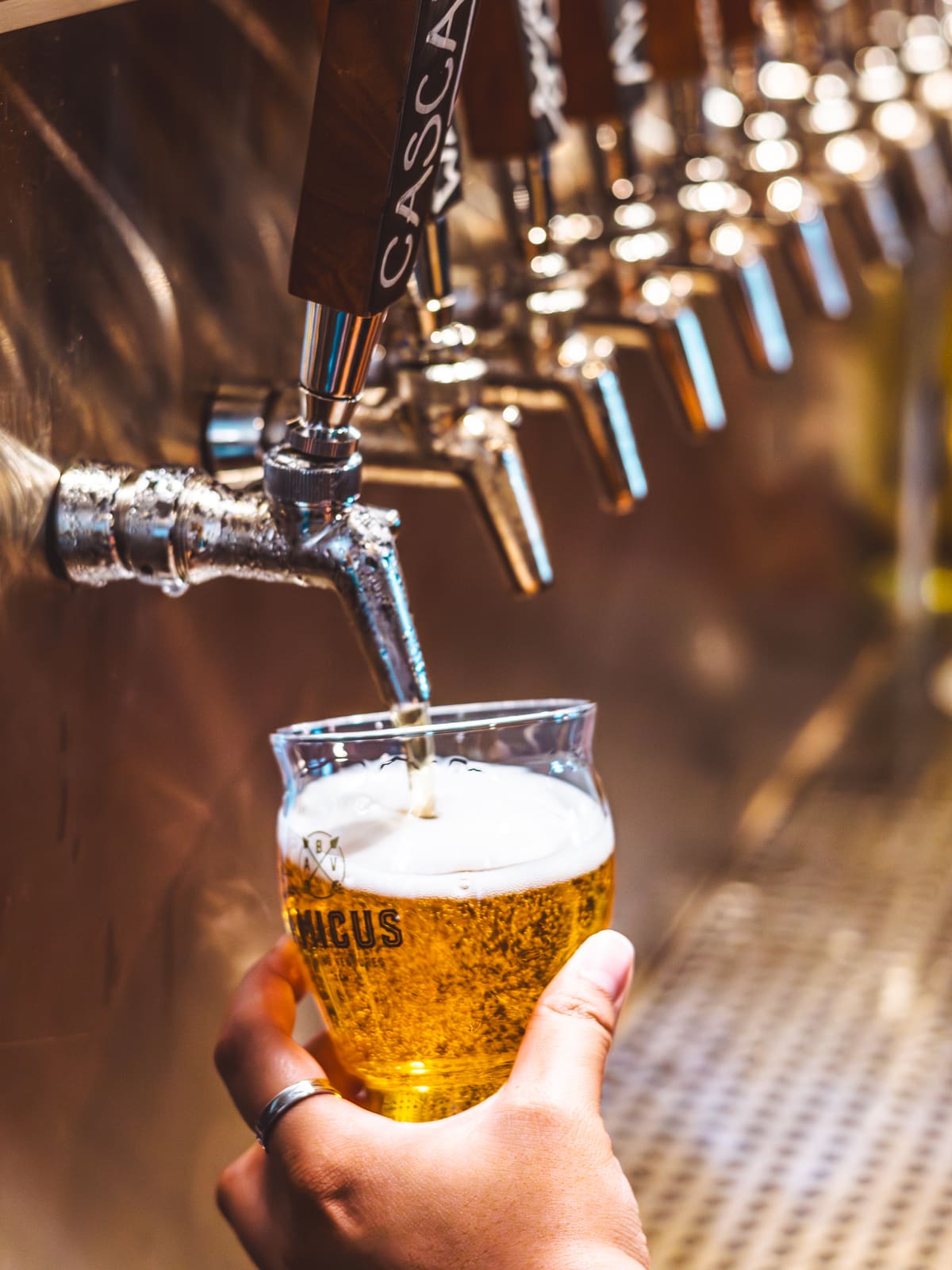 Beer running from a tap into a tilted glass.